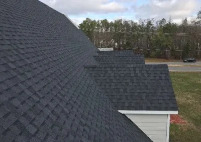A newly installed dark asphalt shingle roof on a building in Richmond, VA.