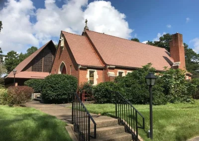 Brick church with asphalt shingle roofing in Richmond, VA done by A Plus Roofing.