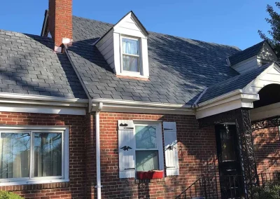 Brick home in Richmond, VA, with a slate roof installed by our roofers at A Plus Roofing.