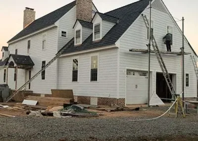 Siding installation in Richmond VA in progress on a residential home with ladders and work equipment.