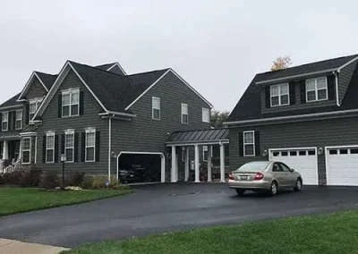 Siding installation in Richmond VA on a residential duplex home with new gray exterior siding.